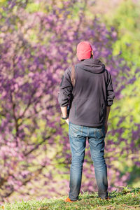 Rear view of man standing on grassy field