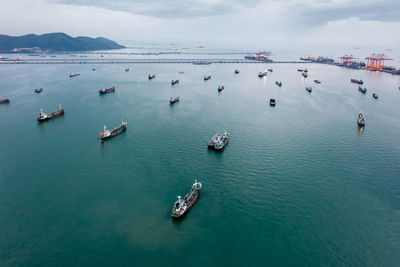 Group of transport ships waiting to carry oil,gas,petrochemicals for export,floating in sea 