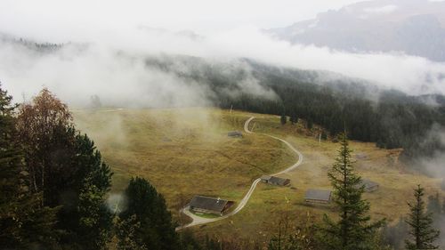 Scenic view of landscape against sky during foggy weather