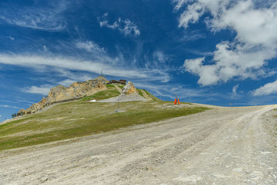 Road leading towards mountain against sky