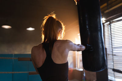 Rear view of woman exercising in gym