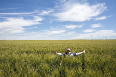 Dog on field against sky