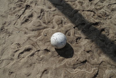 High angle view of soccer ball on sand