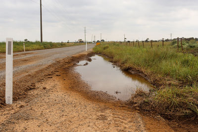 Puddle alongside road edge in countryside