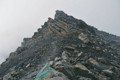 Low angle view of rock formation against sky