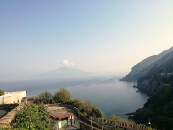 Scenic view of sea and mountains against sky