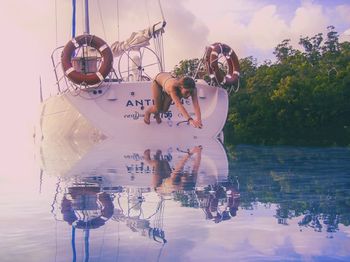 People in boat against sky