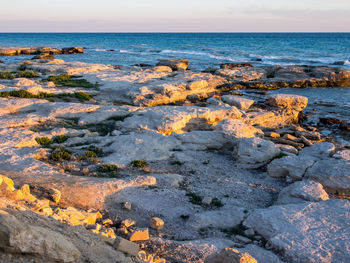 Rocks on beach against sky