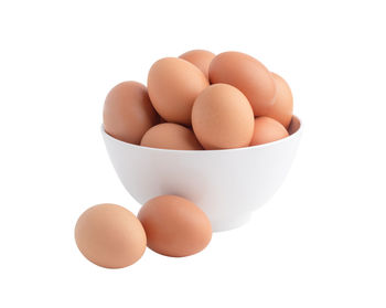 Close-up of eggs against white background