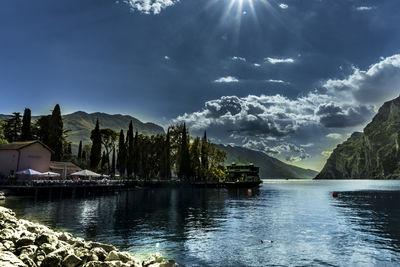 Scenic view of lake by buildings against sky