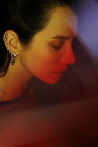 Close-up portrait of young woman looking away