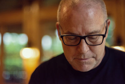 Close-up of mature man wearing eyeglasses at home