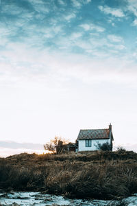 House by trees against sky