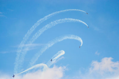 Low angle view of vapor trail against blue sky