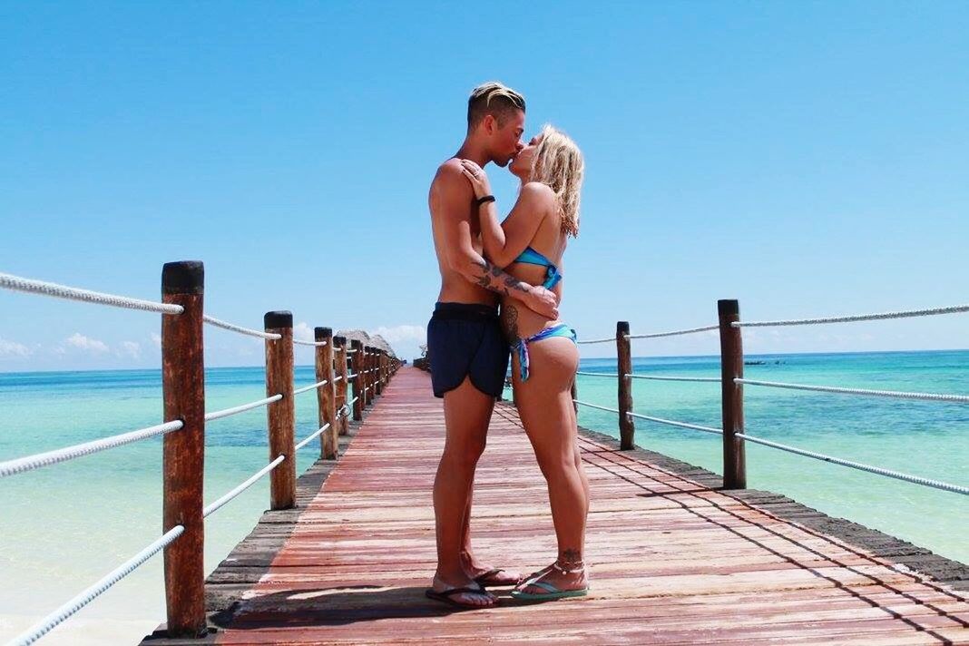 vacations, togetherness, water, two people, sea, enjoyment, pier, bonding, leisure activity, love, travel, clear sky, heterosexual couple, full length, outdoors, blond hair, water's edge, boardwalk, travel destinations, summer, people, adult, day, women, horizon over water, adults only, beach, nature, young women, sky