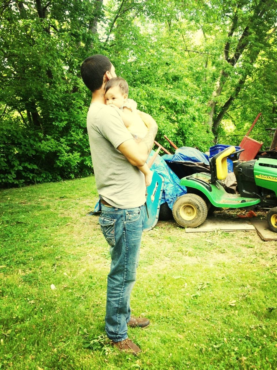 lifestyles, grass, casual clothing, full length, leisure activity, tree, childhood, green color, person, field, holding, elementary age, grassy, boys, men, standing, outdoors, day