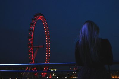 Low angle view of illuminated ferris wheel against sky at night