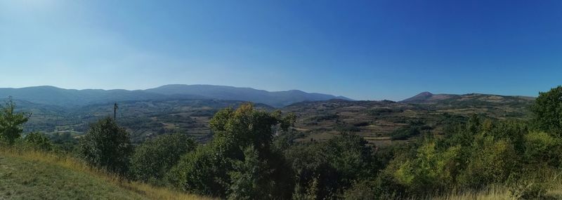 Scenic view of mountains against clear blue sky