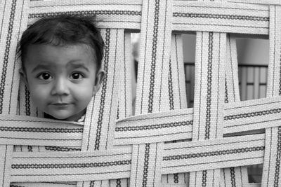 Close-up portrait of cute girl peeking