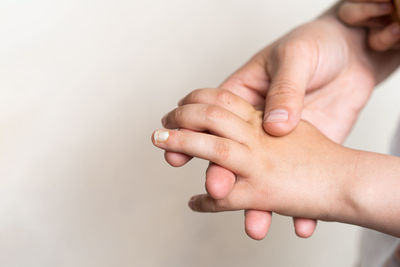 A boy's hand with a chipped nail.