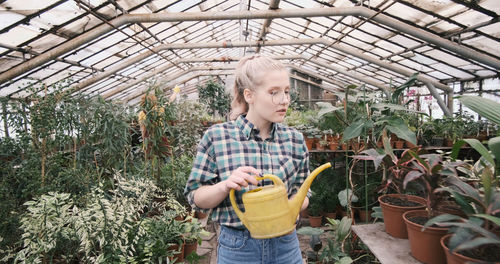 Man and woman standing in greenhouse