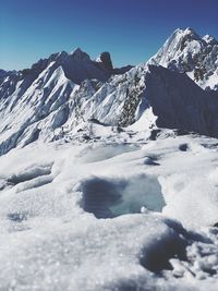 Scenic view of snowcapped mountains against clear sky