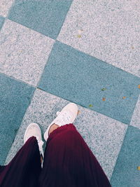 Low section of woman standing on tiled floor