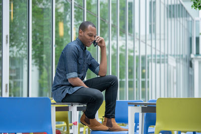 Side view of man using mobile phone