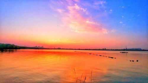 Scenic view of lake against sky during sunset