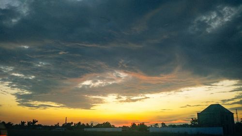 Silhouette trees against sky during sunset