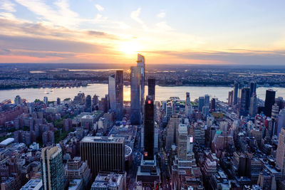 Panoramic view of city buildings against sky during sunset