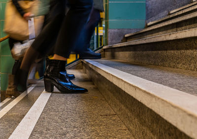 Low section of people walking on staircase