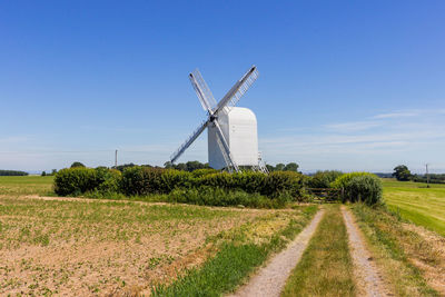 Windmill on field against sky