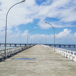 View of street leading towards sea against sky