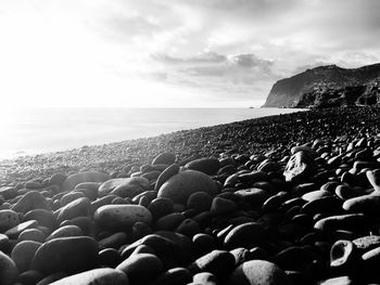 Rocks on beach against sky