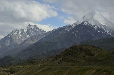 Scenic view of snow covered mountains against sky