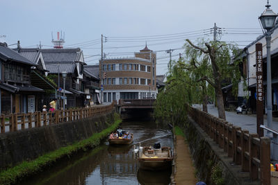 Canal amidst buildings against sky