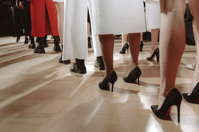 Low section of people dancing on hardwood floor