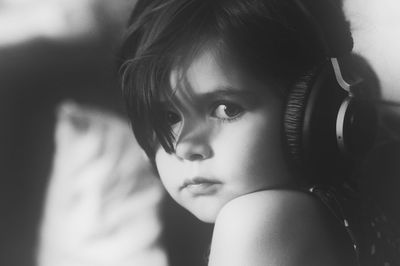 Portrait of girl listening music through headphones