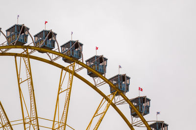 Low angle view of ferris wheel against clear sky