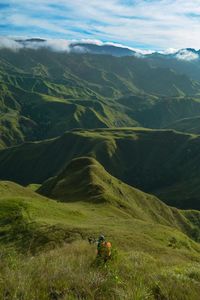 Scenic view of green landscape against sky