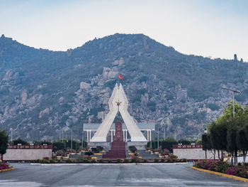 View of temple and building against sky