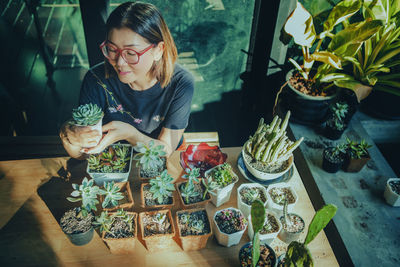 High angle view of woman holding food on table