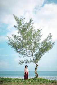 Man standing by sea against sky