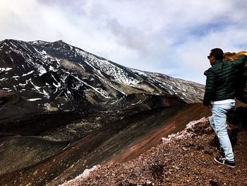 Man standing on mountain against sky