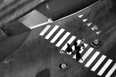 High angle view of people walking on zebra crossing