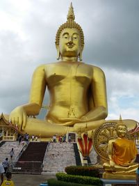 Low angle view of statue against temple against sky