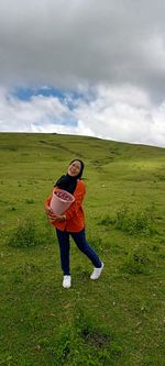 Rear view of woman standing on field