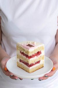 Midsection of woman holding cake