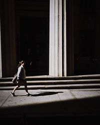Full length of woman standing by railing